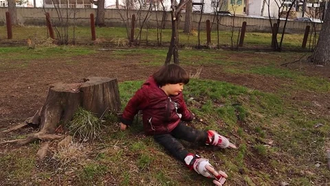 Child Learning Roller Skating Alone in Park Building Confidence Stock Footage 333589713