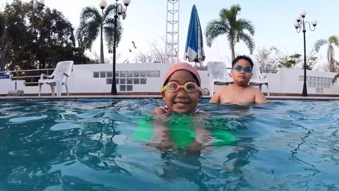Child learning to swim in swimming pool Stock Footage 101177762