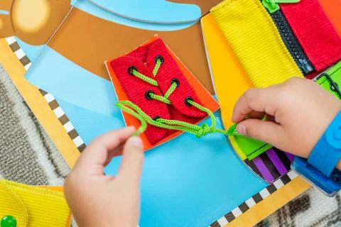 Child is learning to tie the laces Stock Photos