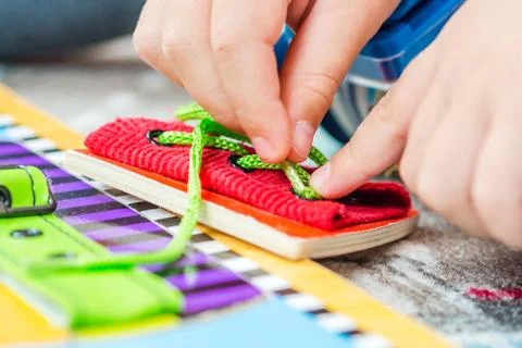 Child is learning to tie the laces Stock Photos