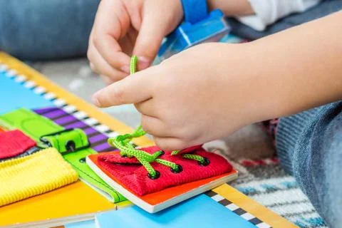 Child is learning to tie the laces Stock Photos