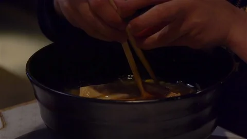 Child learning to use chopsticks Stock Footage 125706576