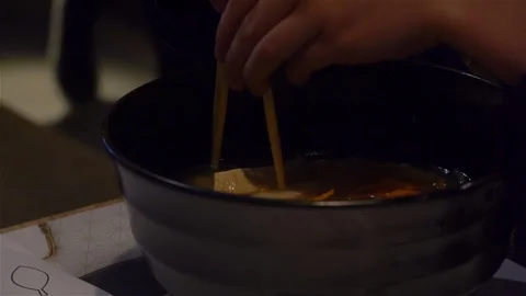 Child learning to use chopsticks Stock Footage 125738140