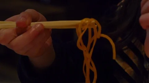 Child learning to use chopsticks Stock Footage 125738153