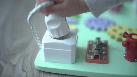 Child learning to use a power plug with montessori method Stock Footage 158951177