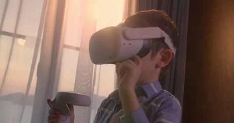 Child learning using virtual reality headset. Modern education child in virtual Stock Footage 241536139