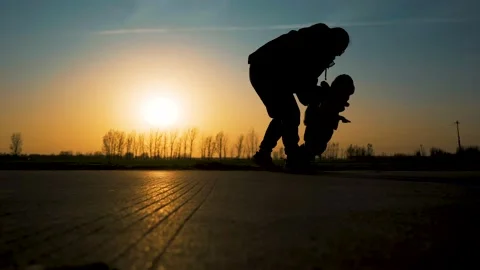 Child learning to walk in the sunset Stock Footage 221533617