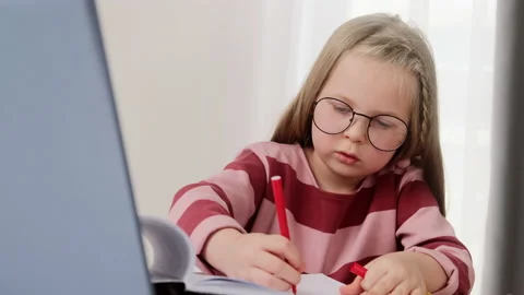 Child learning writing a task online with laptop, doing homework studying Stock Footage 151680770