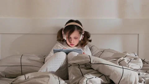 The child learns and talks on the computer with headphones. Video in life style Video stock 170887927