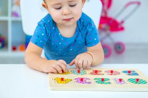 The child learns numbers at the table. Selective focus. Stock Photos