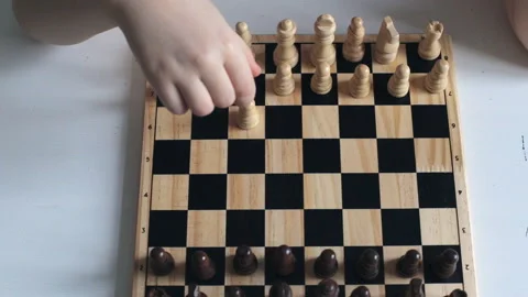 The child learns to play chess. Game of chess child and adult Vídeos de archivo 161243204