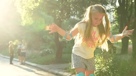Child learns to ride on roller skates.Summer activities for children. Stock Footage 277719299