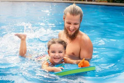 Child learns to swim in the pool Stock Photos