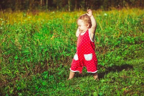 The child learns to walk on the grass Stock Photos