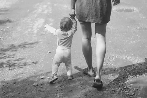 The child learns to walk on the grass Stock Photos