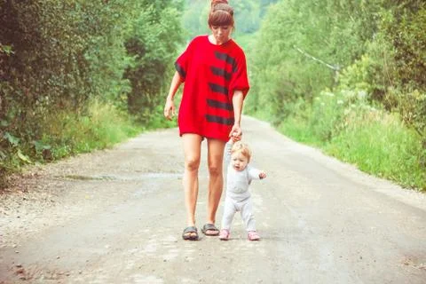 The child learns to walk on the grass Stock Photos