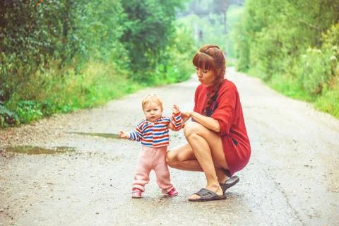 The child learns to walk on the grass Stock Photos