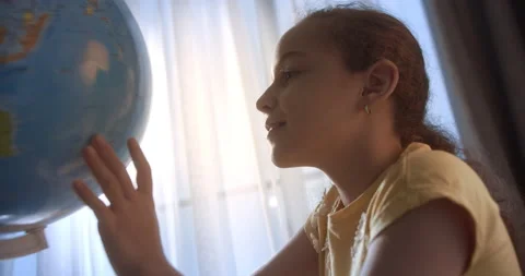 The child learns while sitting at home in the room. Kid in morning light, cute Stock Footage 221409667