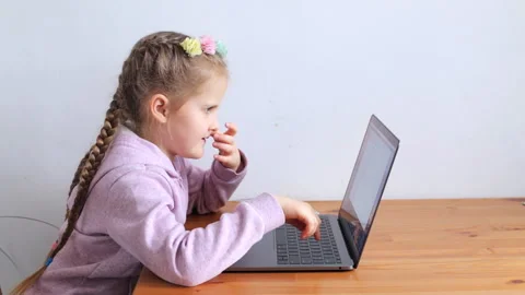 The child learns while sitting at the laptop. Homeschooling concept Stock Footage 150080725