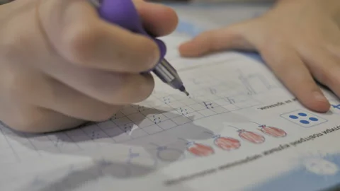 A child learns to write.  Stock Footage 122755360