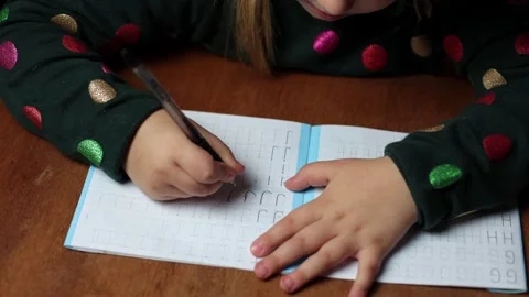 The child learns to write at home, draws a letter. Stock Footage 288581092