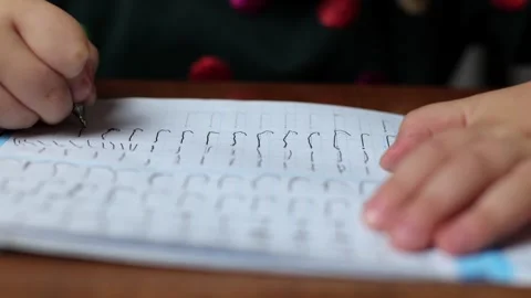 The child learns to write at home, draws a letter. Stock Footage 288581422