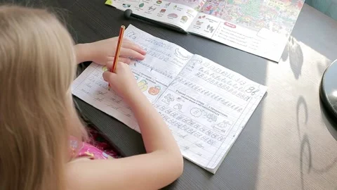 Child learns to write in a note Stock Footage 157883283
