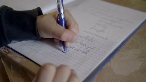 Child learns to write in the notebook. Video stock 154581806