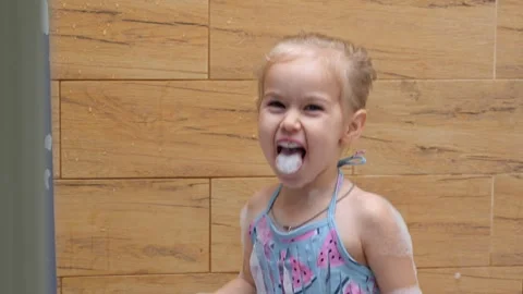 Child licked the foam in the bathroom Stock Footage 321933804
