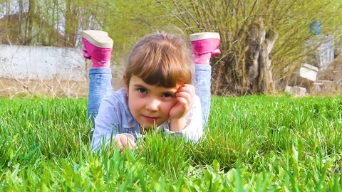 The child lies on the grass Stock Footage 88671157