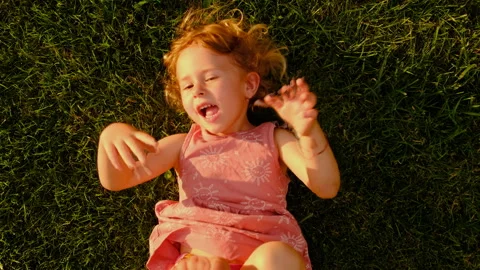 The child lies on the grass. Selective focus. Stock Footage 278276580