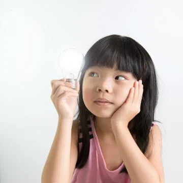 Child with light bulb Stock Photos