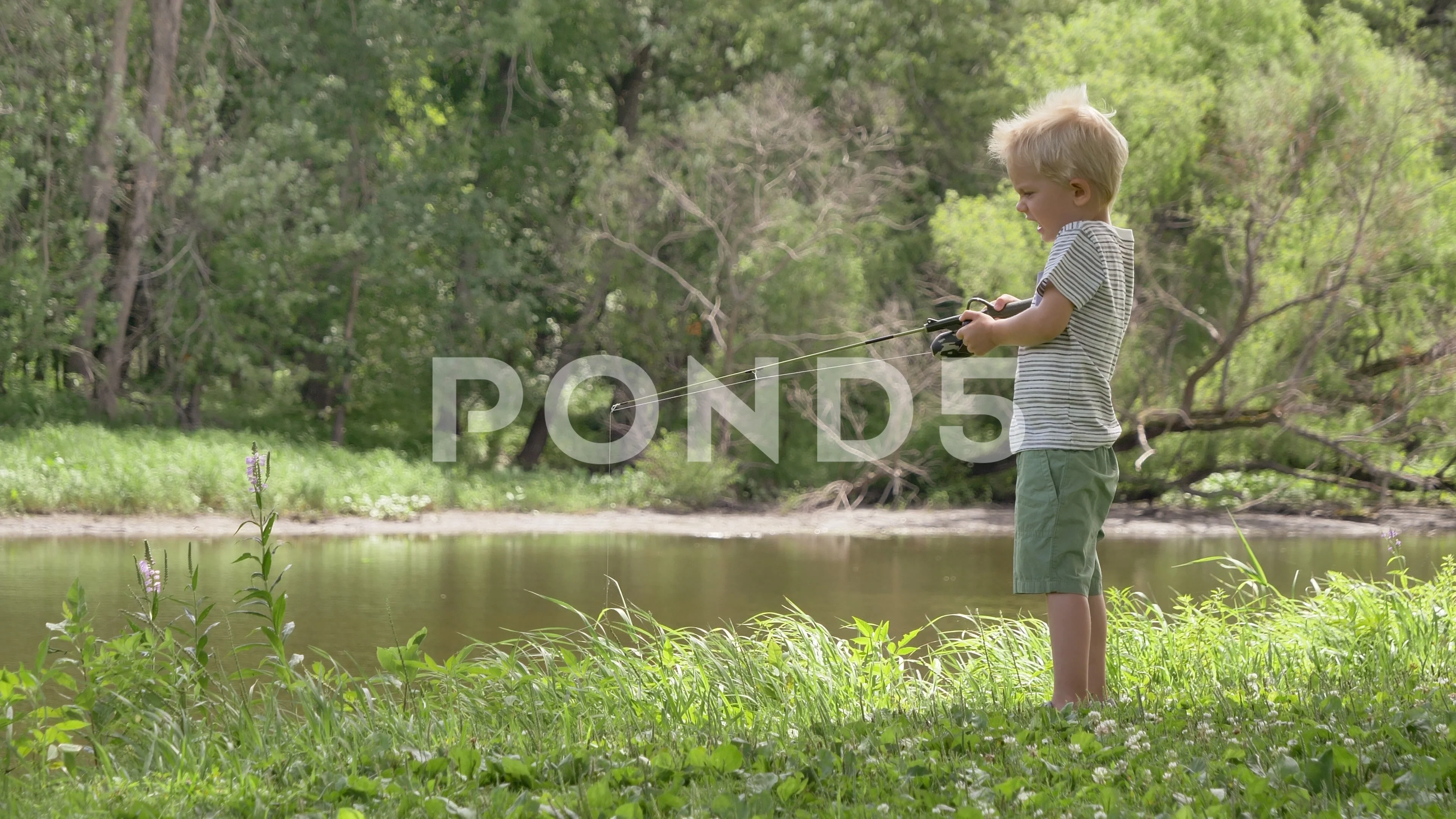 Child (little boy) catching fish, holdin, Stock Video