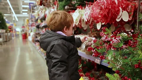 A child is looking at Christmas decorations Stock Footage 166961802