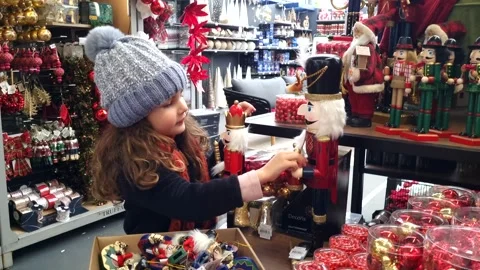 Child looking with curiosity and touching a beautiful Christmas decoration. Stock Footage 257418967