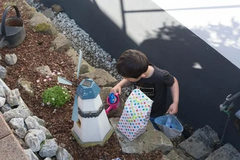 A child looking for Easter egg in the garden Stock Photos