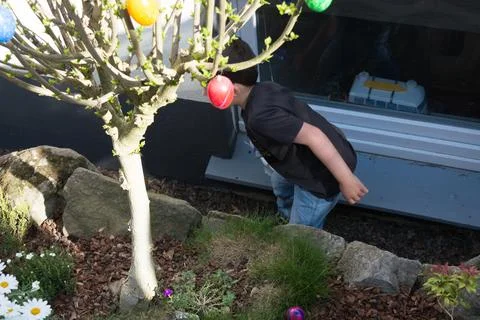 A child looking for Easter egg in the garden Stock Photos