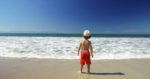 Child looking at the ocean waves.  Stock Footage 102689955