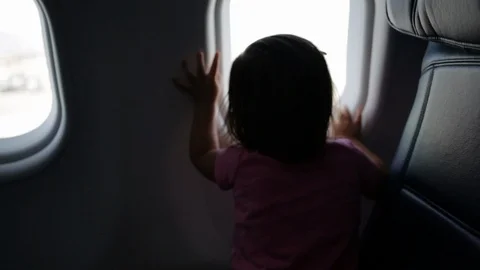 Child Looking Out of Airplane Window Stock Footage 85520500