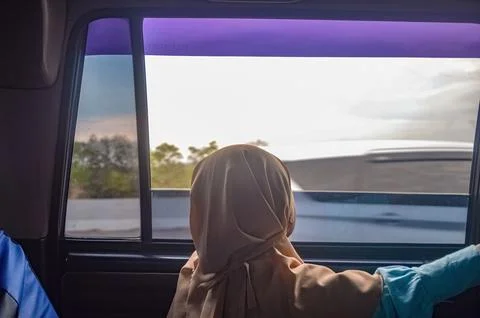 A child looking out the car window while traveling Stock Photos