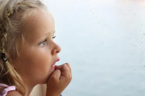 Child looking out of window Stock Photos