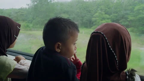 Child looking out the window on the train In Malaysia Asia Stock Footage 134720705