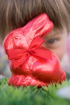 Child looking at red Easter Bunny Stock Photos
