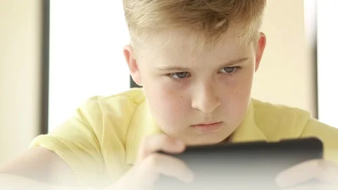  Child looking at a smart phone.  Stock Footage 109417236