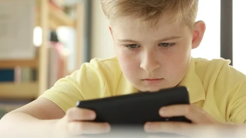  Child looking at a smart phone.  Stock Footage 109417246