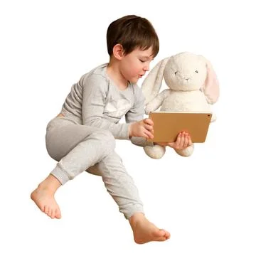 Child looking at tablet with plush rabbit toy isolated on white background... Stock Photos