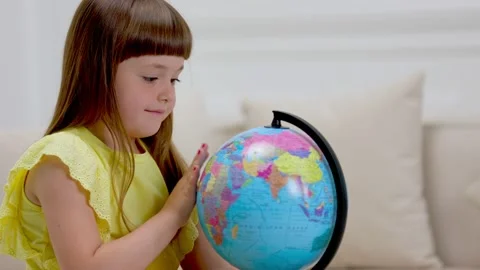 The child looks at the globe Stock Footage 157910332