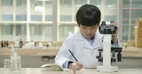 Child looks into microscope in Laboratory School Classroom. Stock Footage 153578183