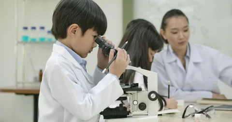 Child looks into microscope in Laboratory School Classroom. Stock Footage 153579278