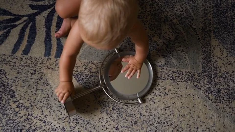 Child looks in the mirror at himself Stock Footage 80241295